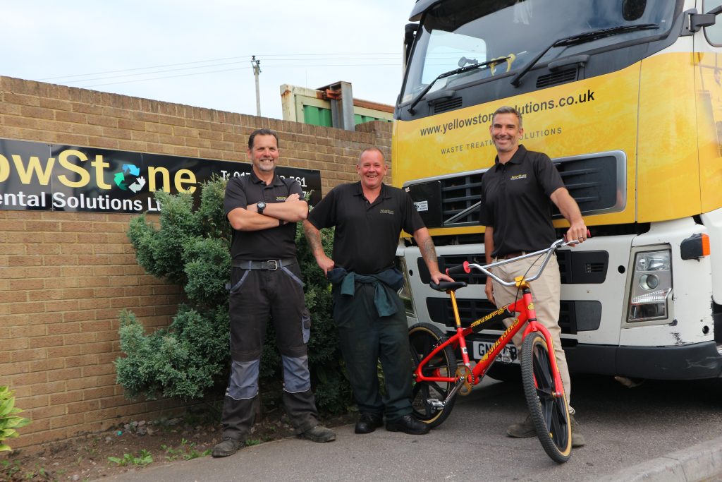 employees stood by yellowstone truck with bmx bike