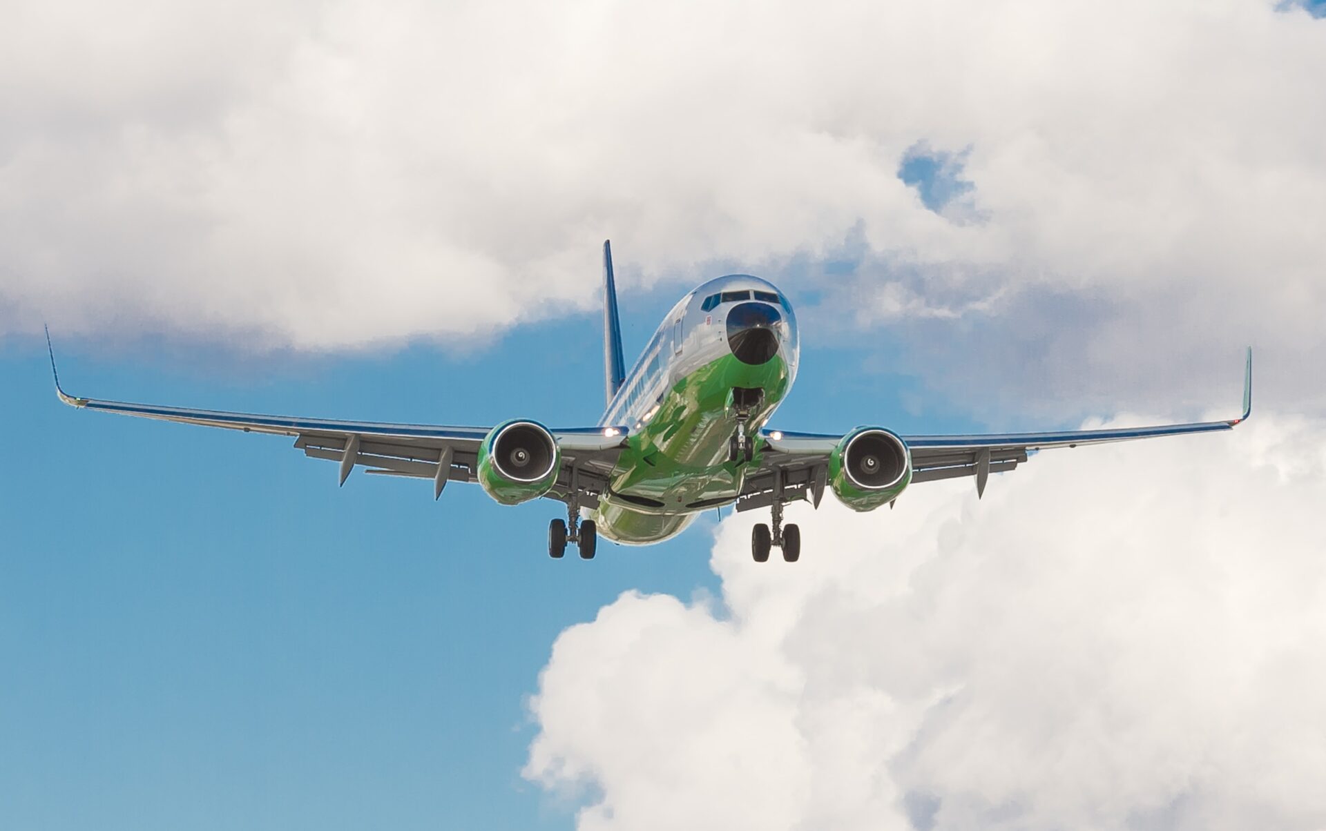 plane flying in sky amongst the clouds